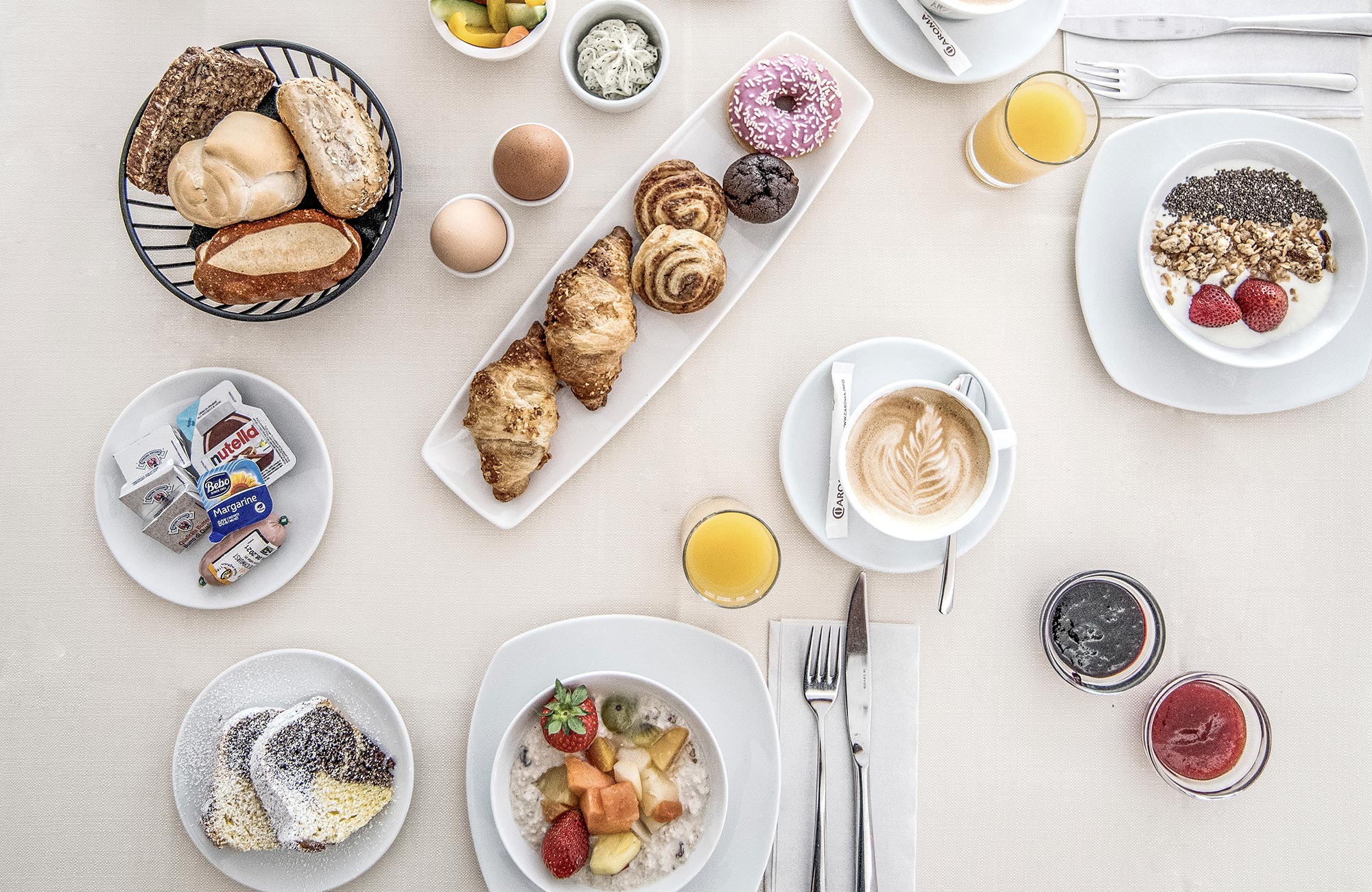 Breakfast table with fresh pastries, yogurt, eggs, jam and coffee - Hotel Wieser