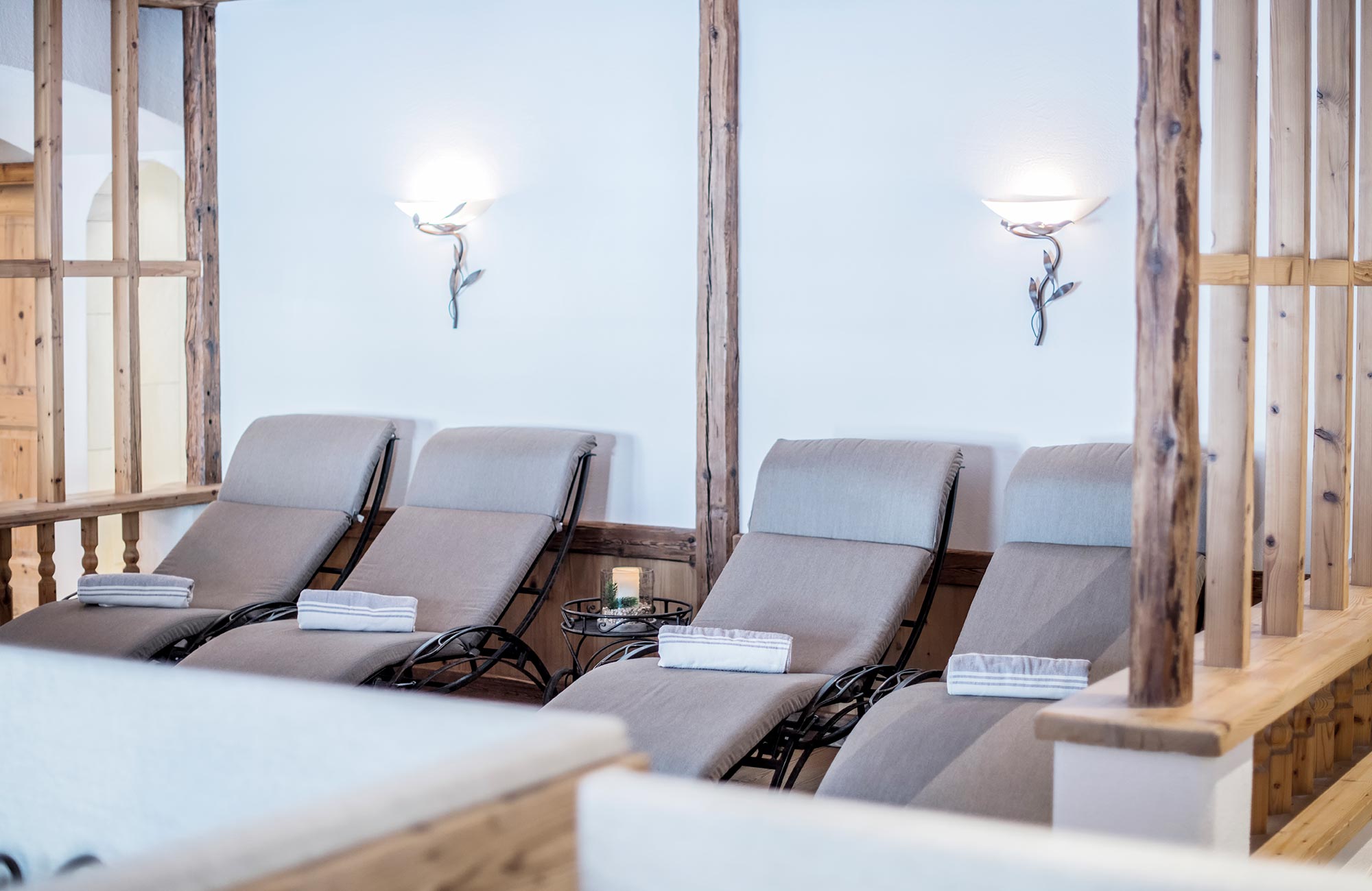 Deck chairs with gray towels on them - Hotel Wieser