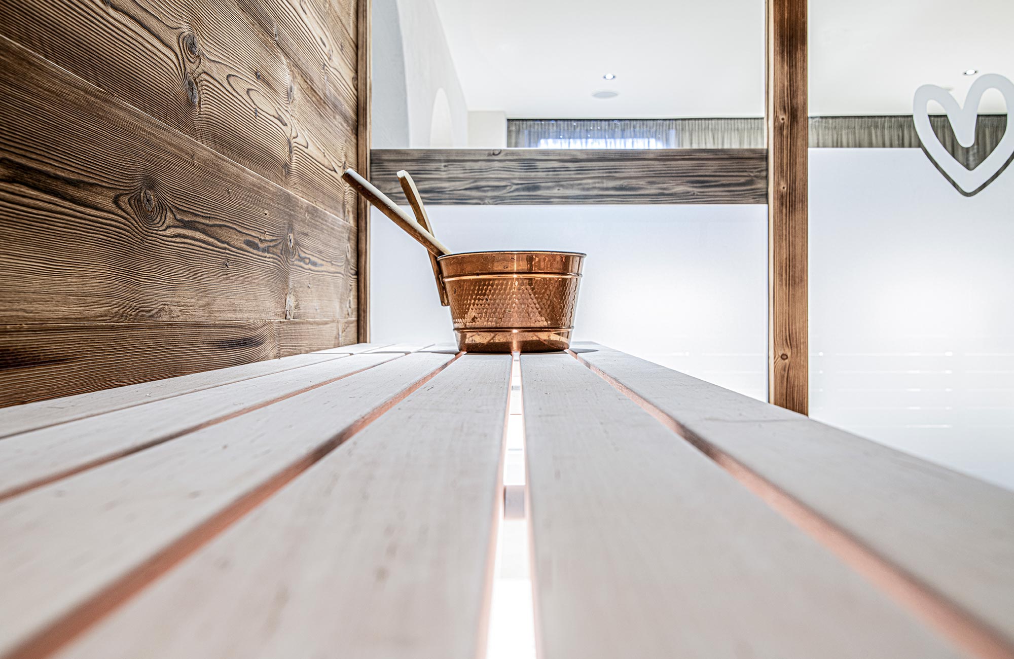 Wooden bench of a sauna with infusion bowl - Hotel Wieser