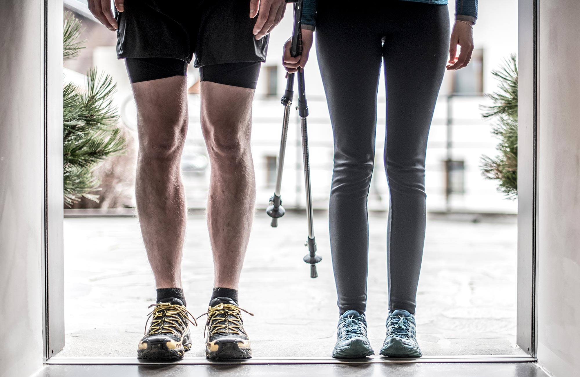 A couple standing in the doorway with hiking boots and walking sticks - Hotel Wieser