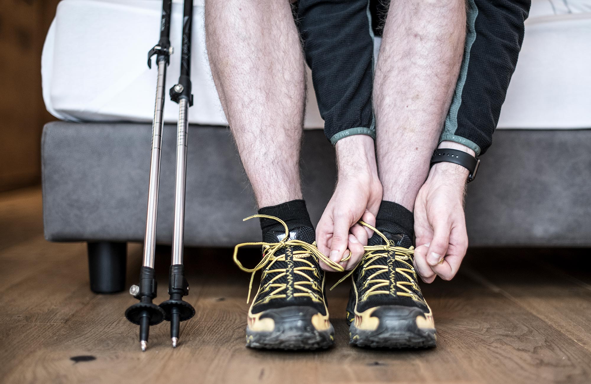 A man laces up his hiking boots - Hotel Wieser