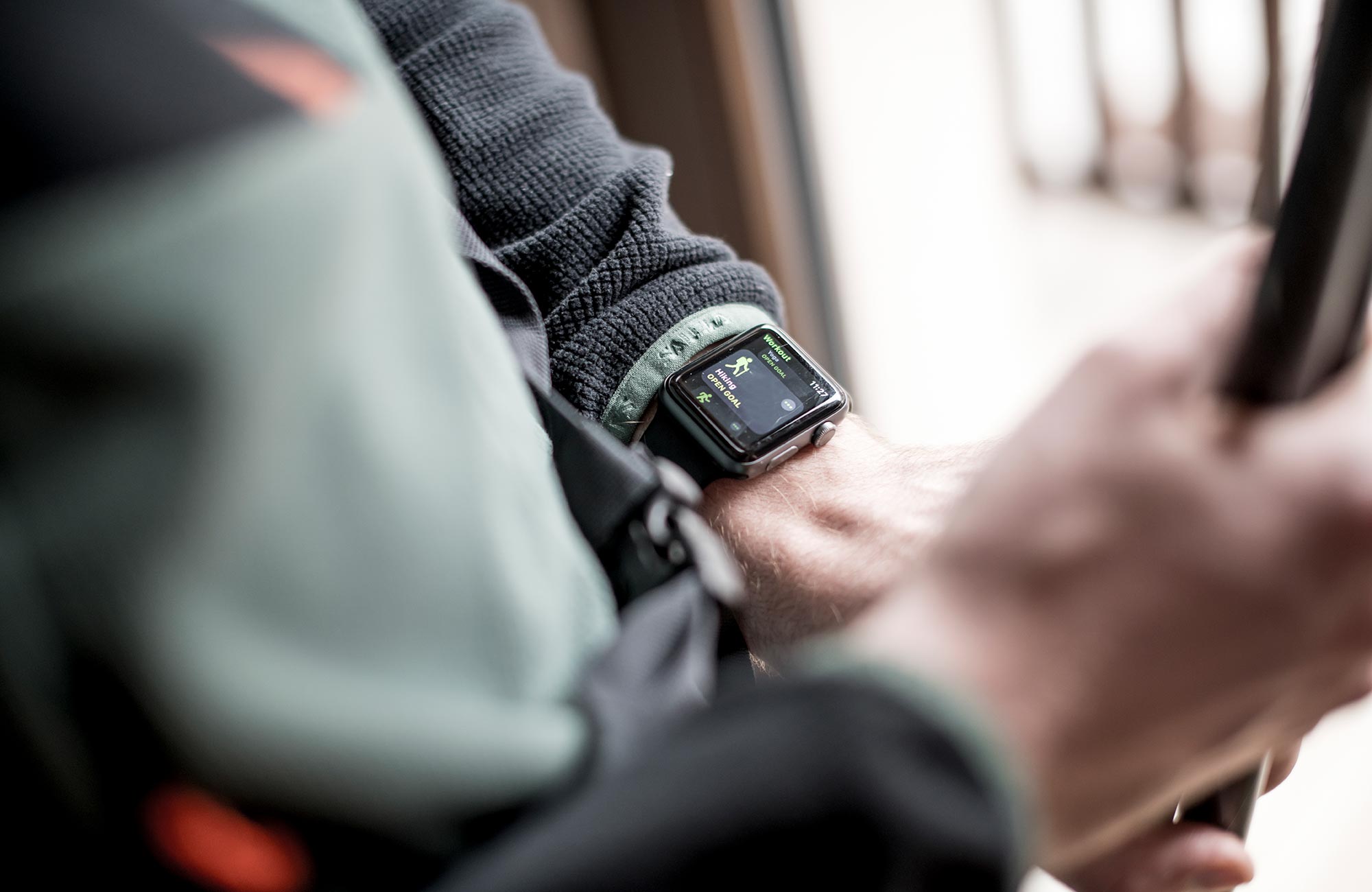 Man looking at his watch to see how long he has been hiking - Hotel Wieser