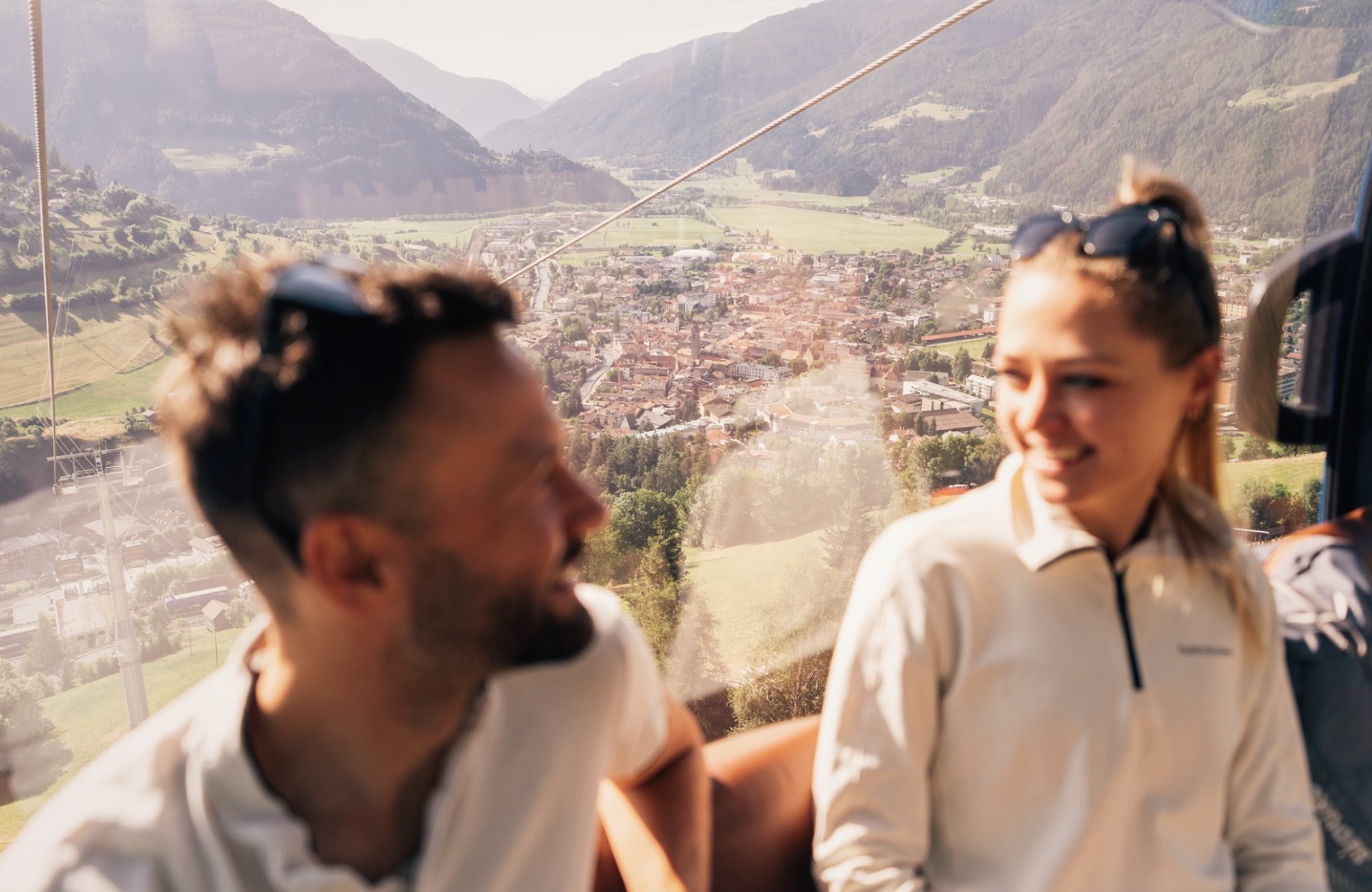 A couple riding a gondola up the mountain - Hotel Wieser