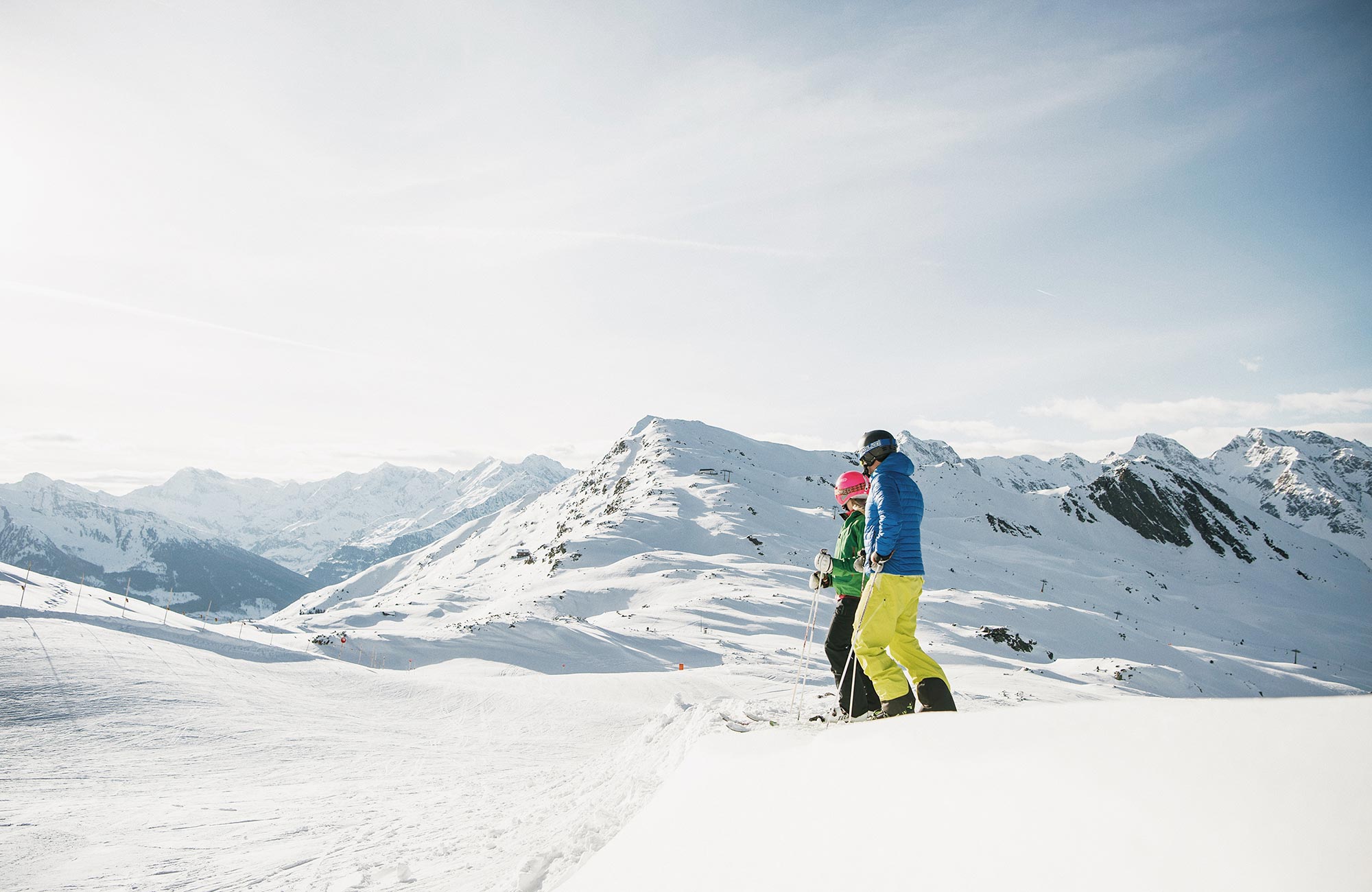 Two skiers in front of the snow-covered South Tyrolean mountains - Hotel Wieser