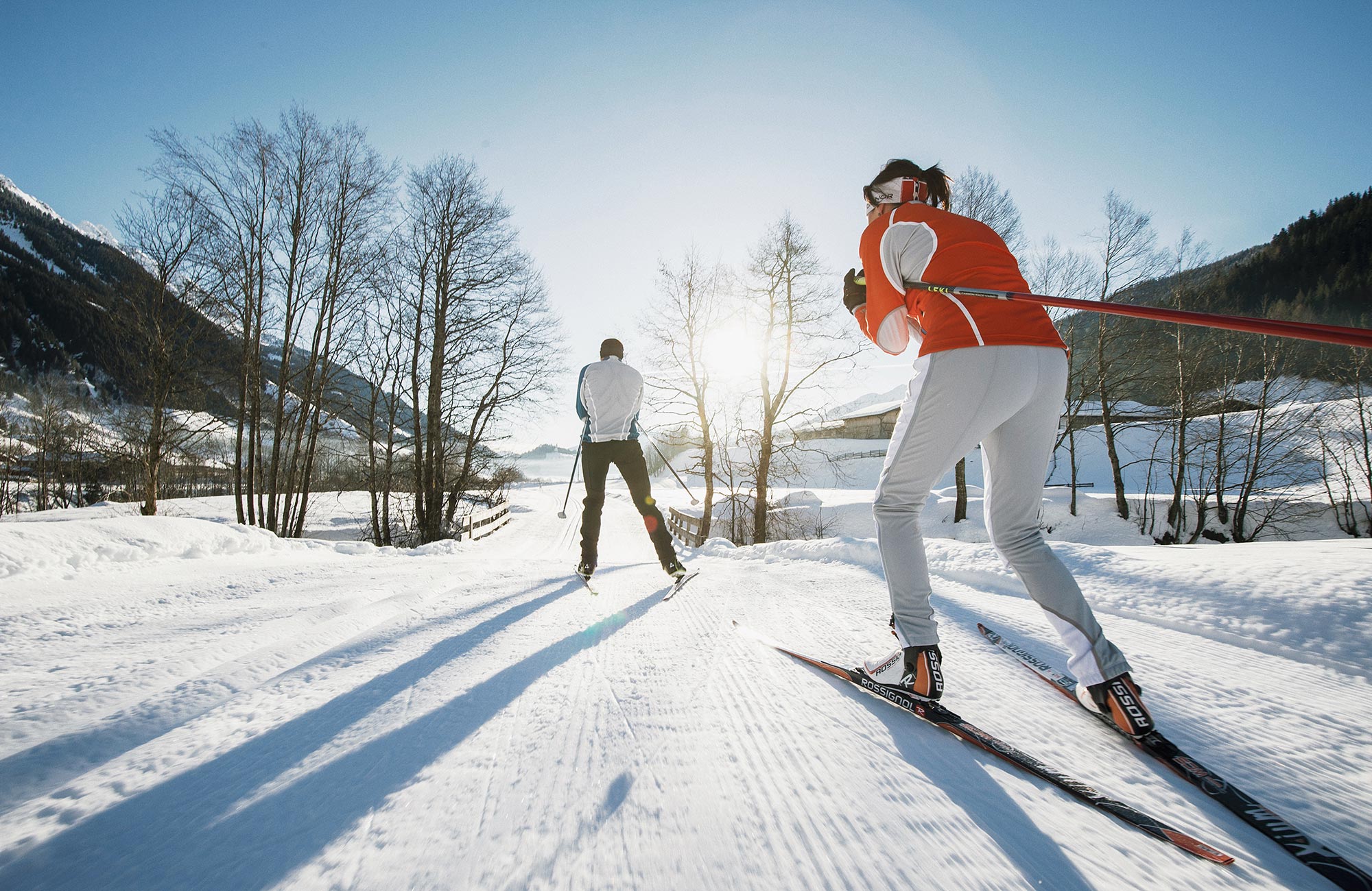 Two cross-country skiers crossing the bridge - Hotel Wieser