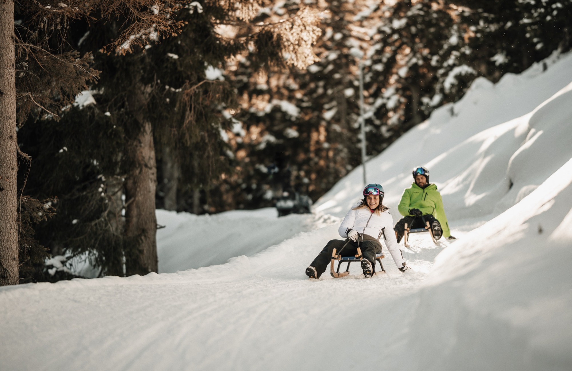 A couple tobogganing down the toboggan run - Hotel Wieser