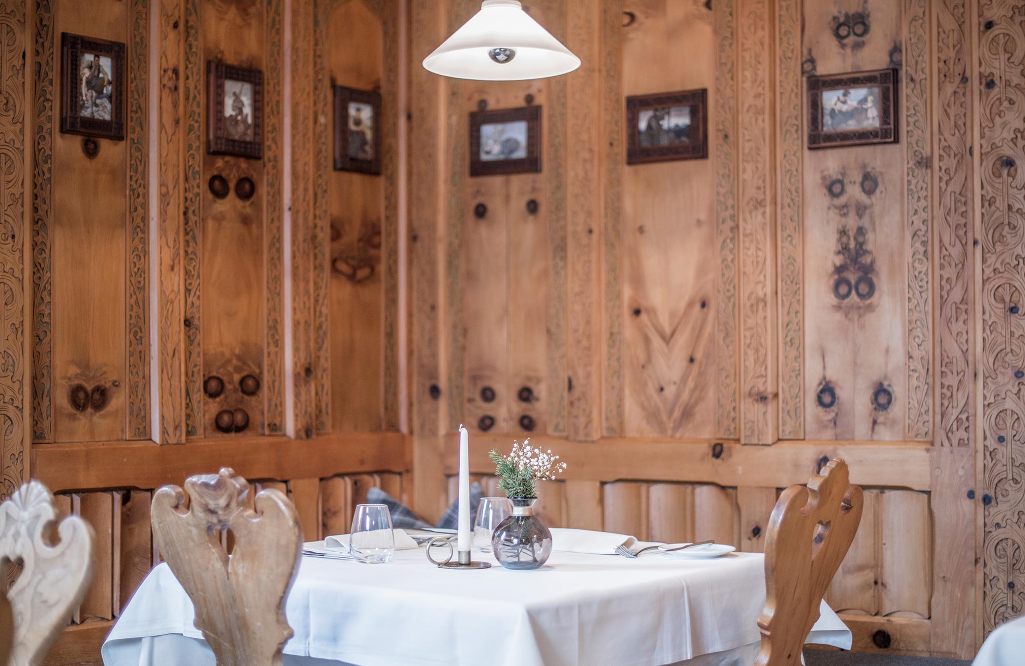 Set table in the Zirben stube with pictures on the wall - Hotel Wieser